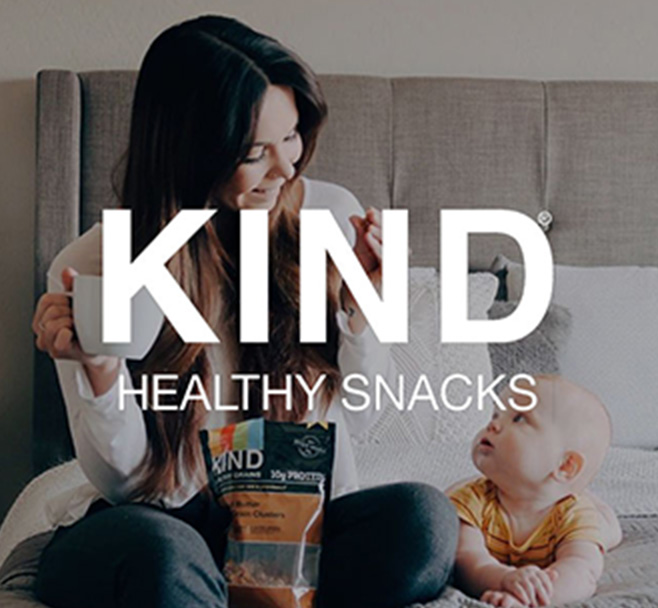 Kind healthy snacks: Woman and baby with a bag of Kind granola
